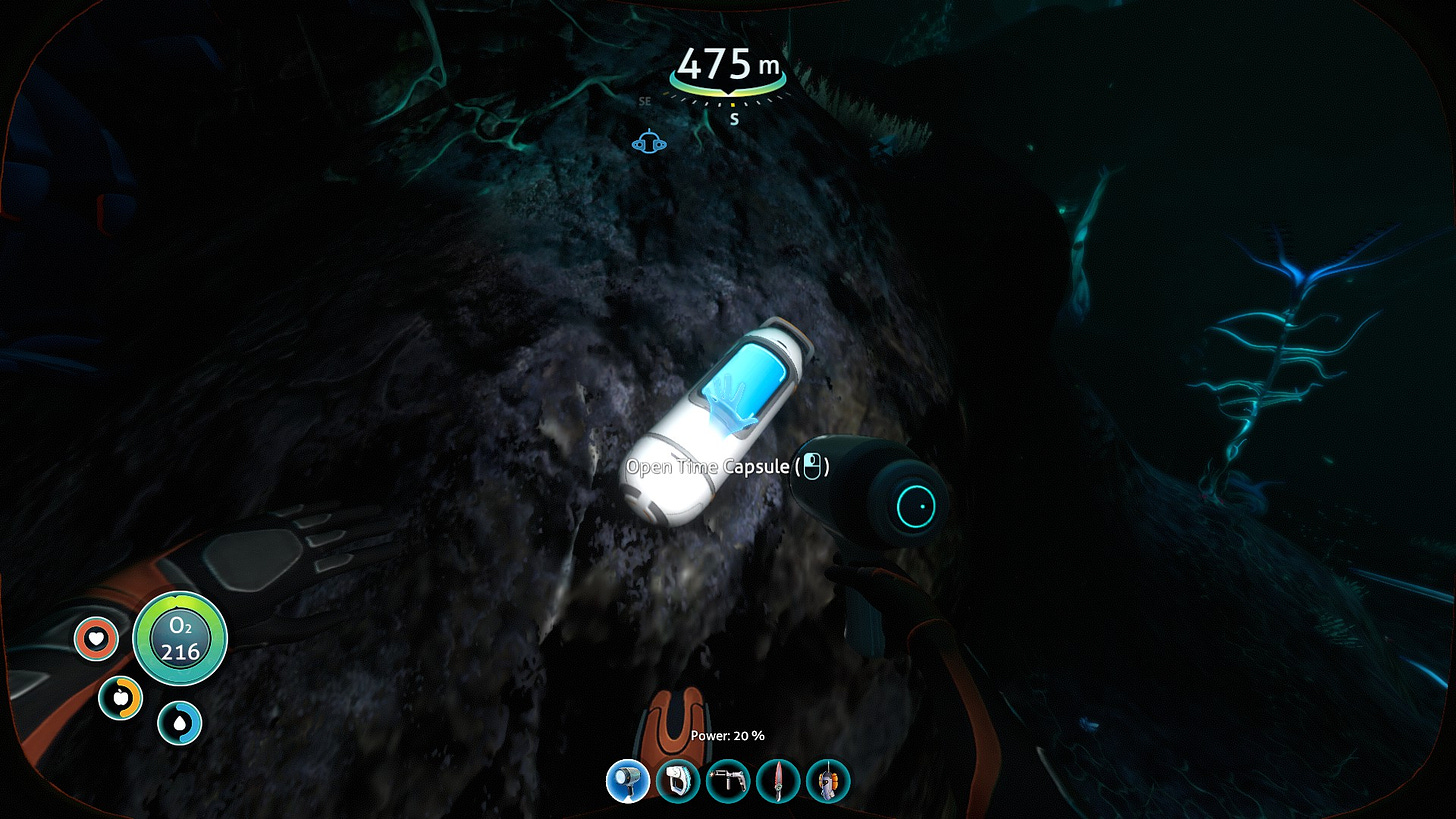 A screenshot of the game Subnautica showing a time capsule designed by the company Alterra deep in the Grand Reef biome of planet 4546B, seen through the player's breathing suit.