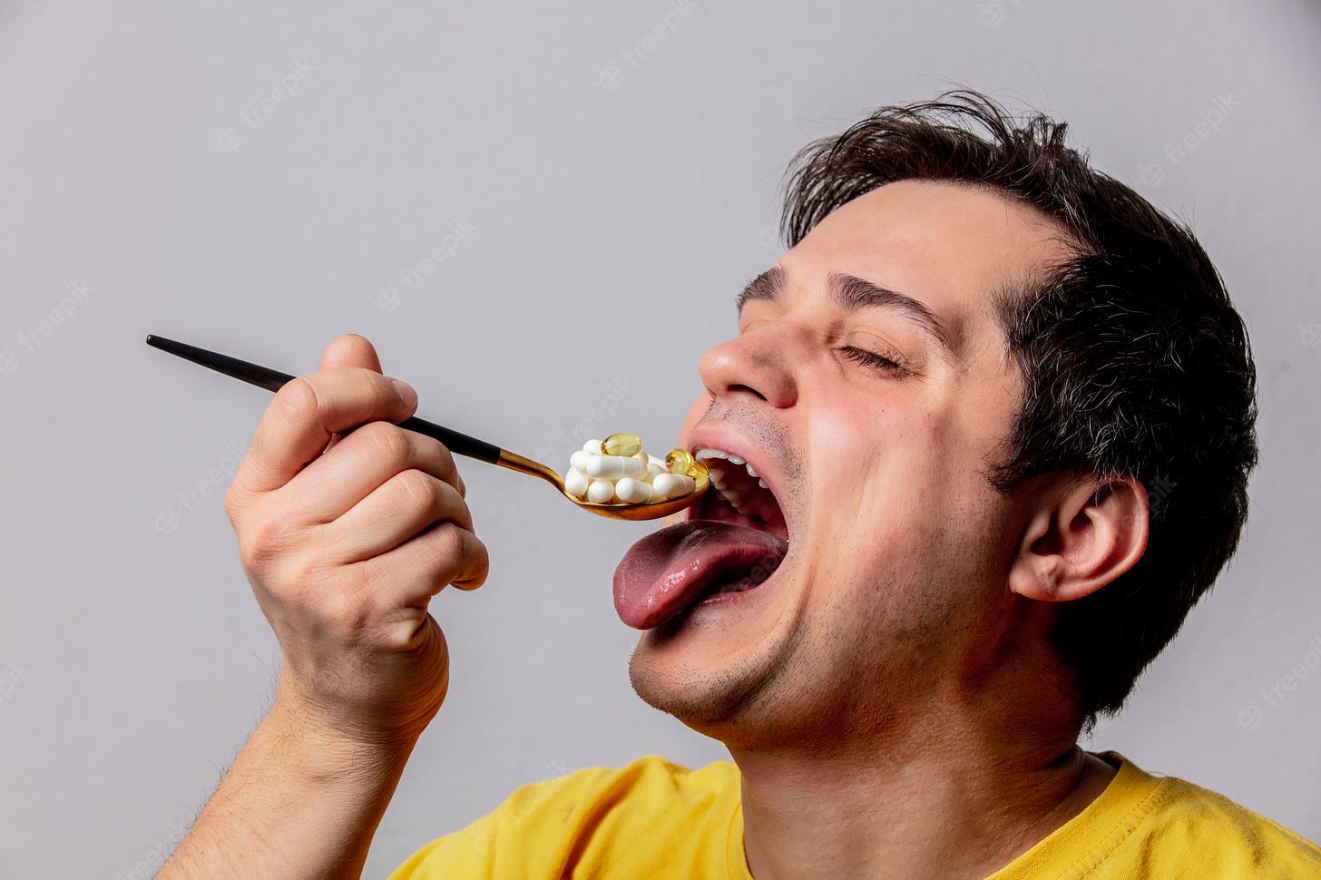 Premium Photo | Man eats a pills with spoon
