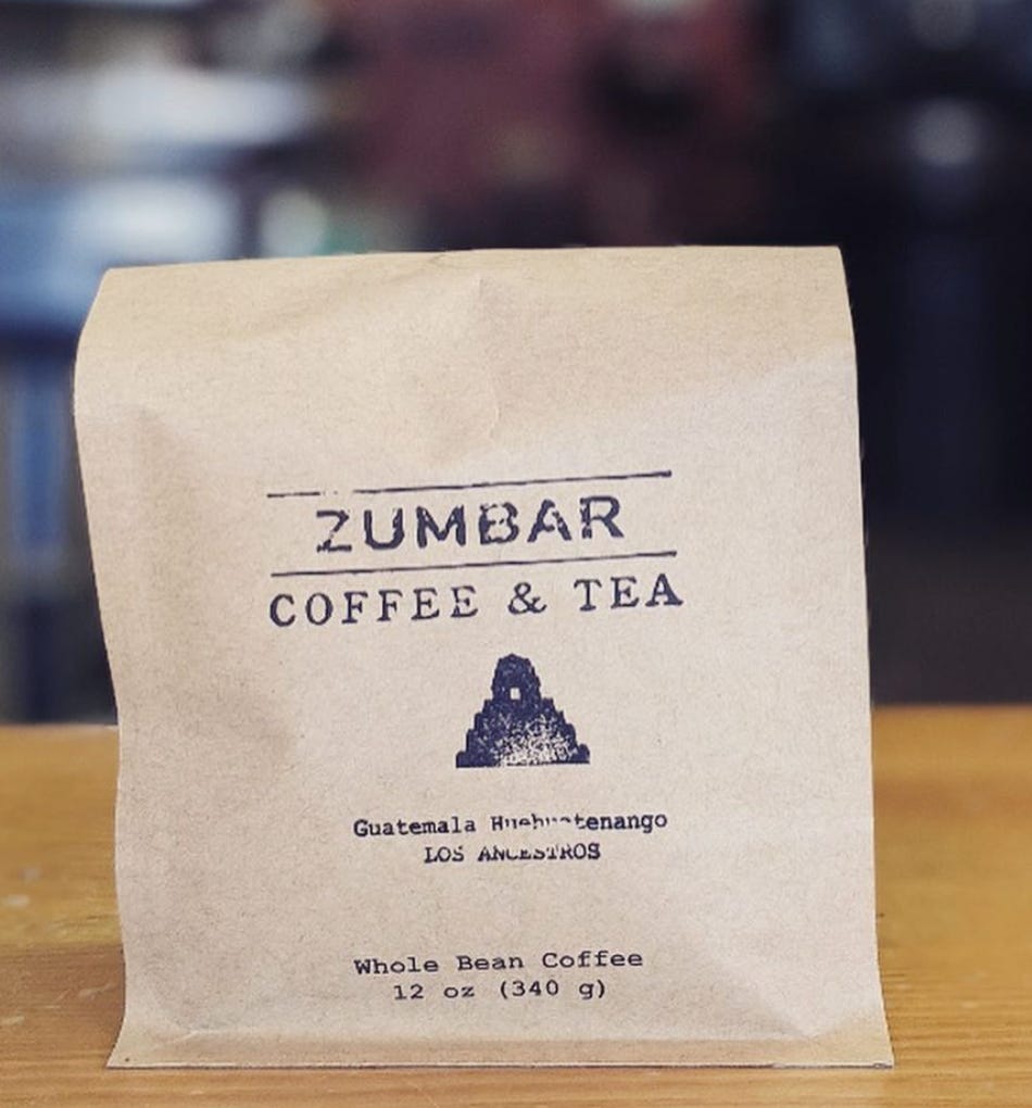 A brown coffee bag with the Zumbar Coffee & Tea logo in black ink.