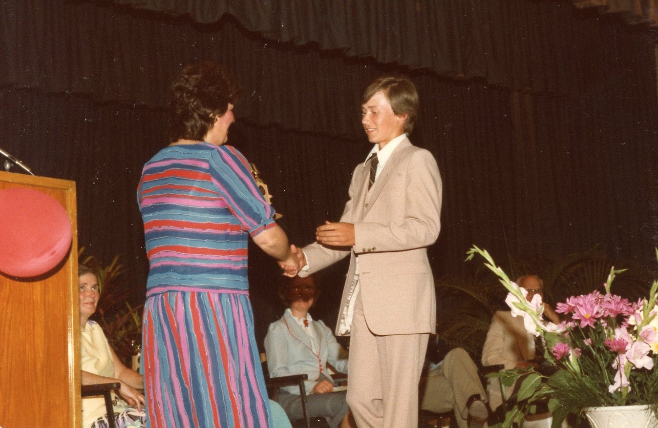 Image of Michael accepting grade nine academic award in 1983