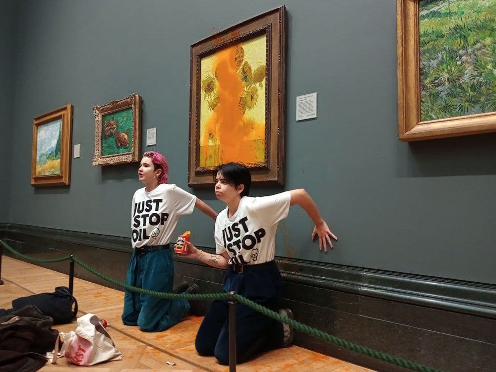 Climate protesters hold a demonstration as they throw cans of tomato soup at Vincent van Gogh's 'Sunflowers'