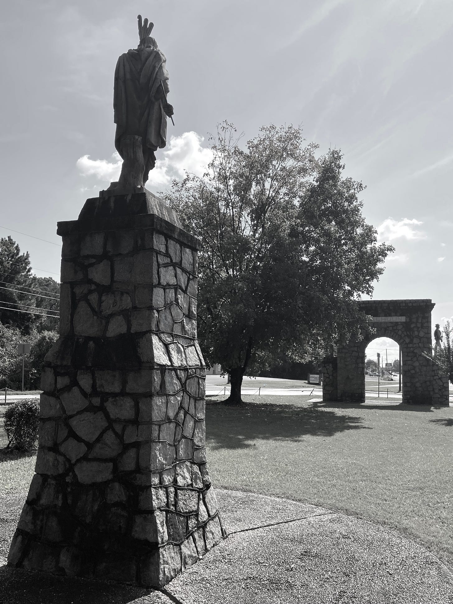 Statue of Sequoyah in foreground facing the Calhoun War Memorial, honoring local World War I and Confederate soldiers. Author Photograph October 9, 2021.