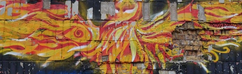 A wall mural of a flaming bird