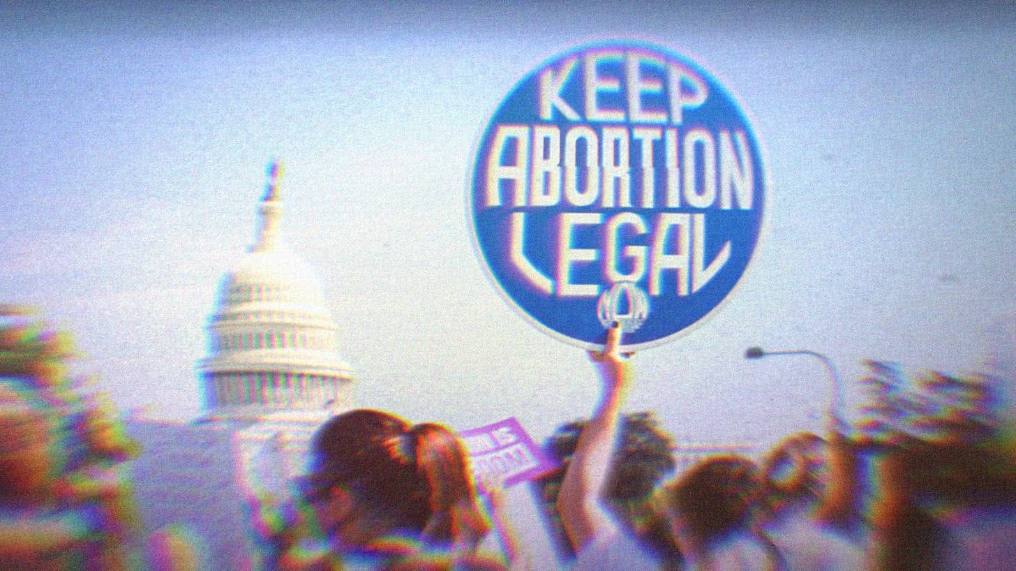 A pro-choice protest at the capitol; the main focus of the image is a sign that says keep abortion legal