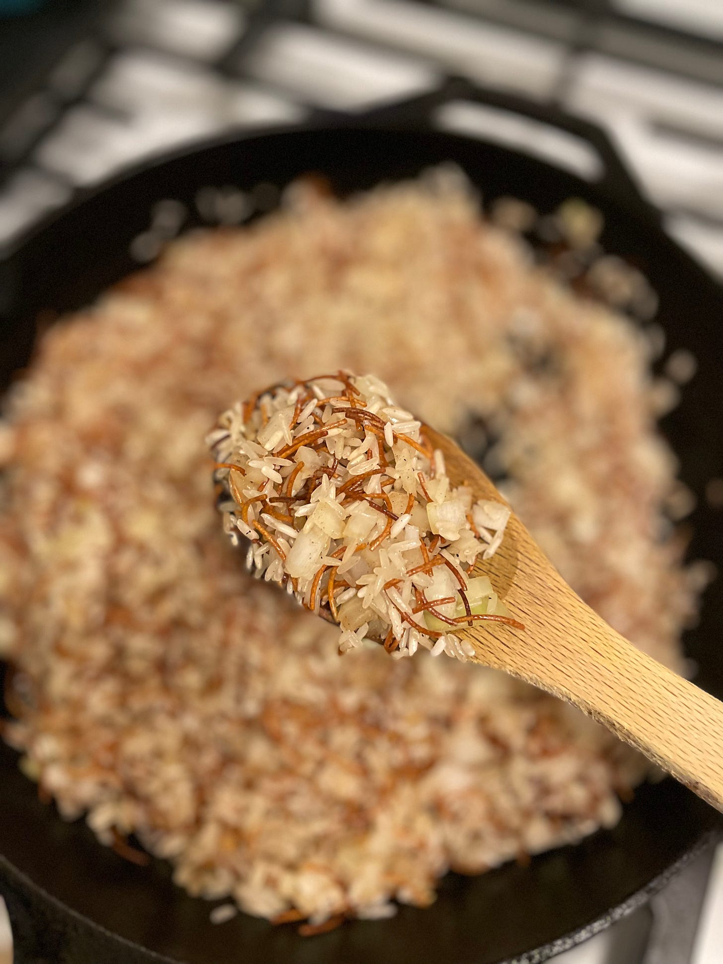 Vermicelli, rice, and onion sauteed in pan