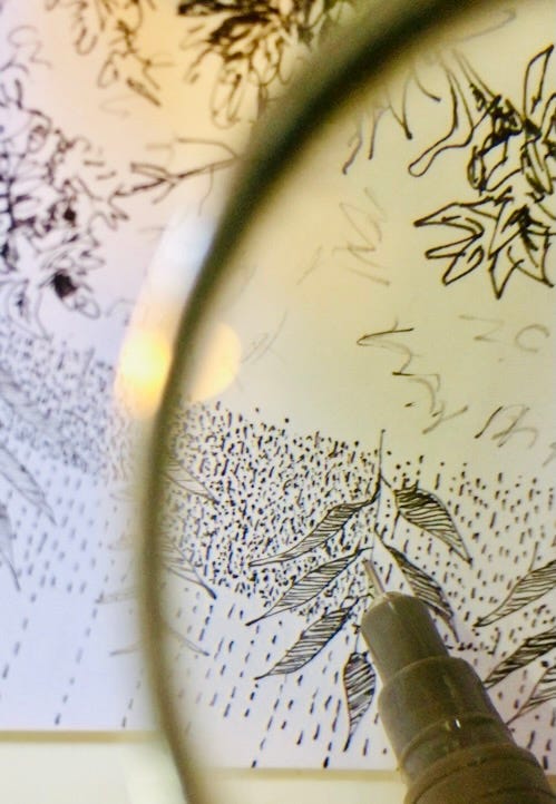 Photo of close up artwork with detailed lines and dots being magnified with a magnifying glass