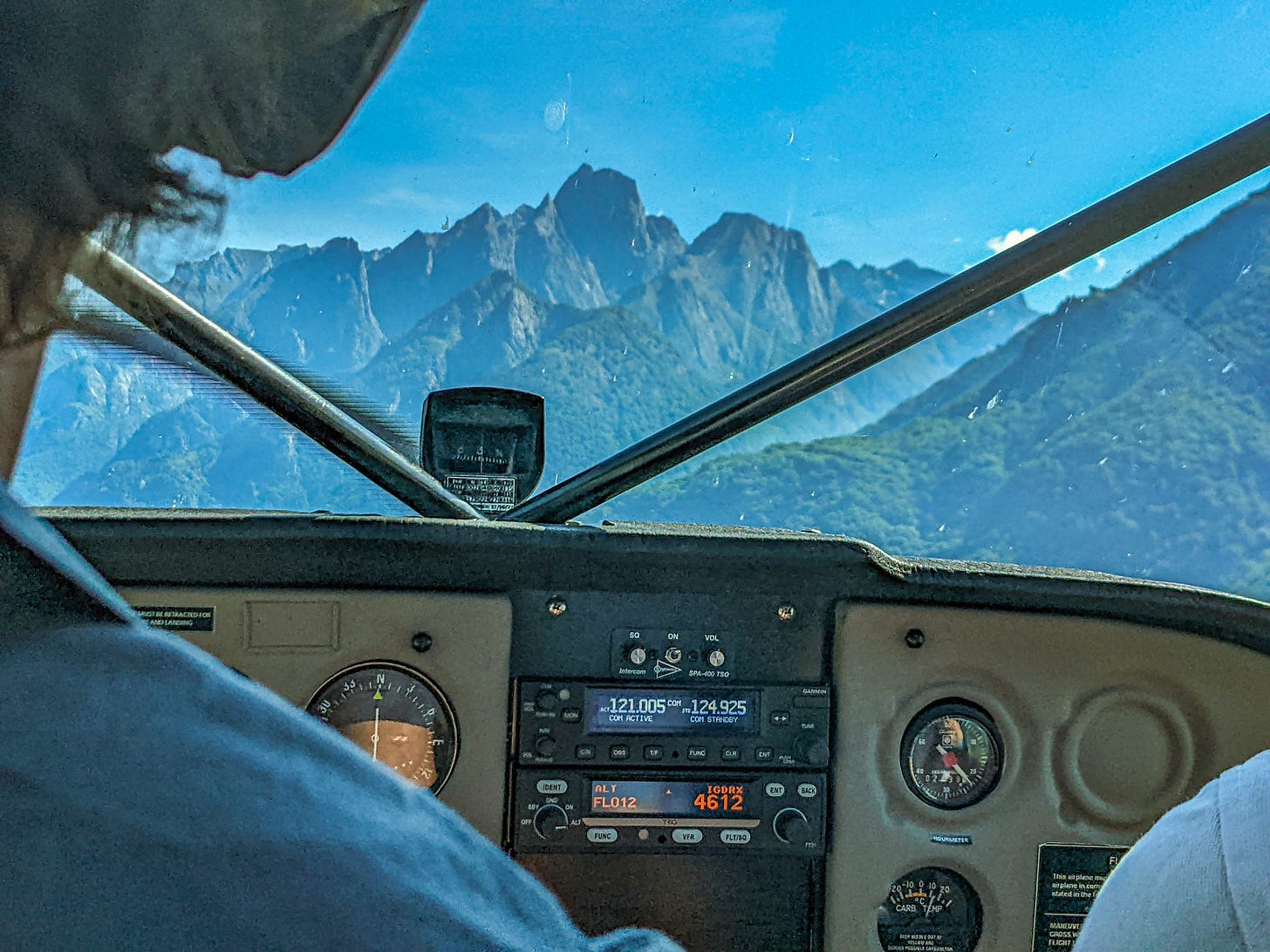 A view through the front of the plane, the Lepontine Alps directly ahead of us. 