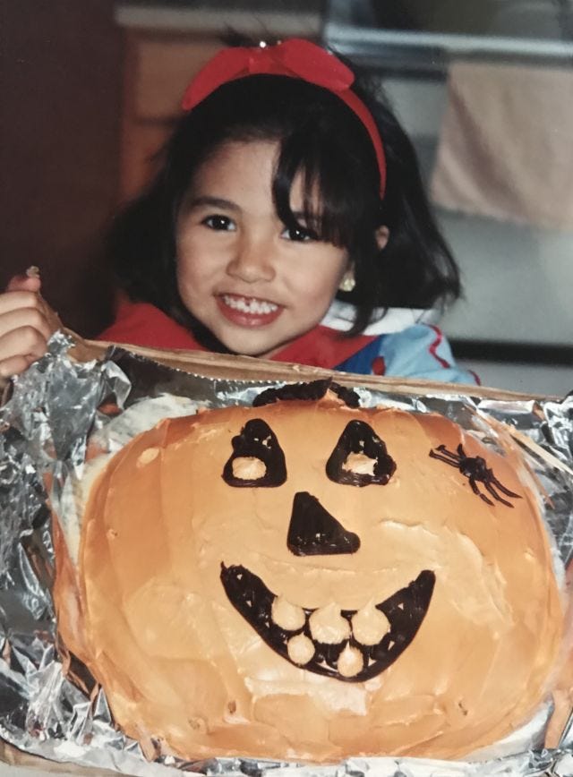 baby halloween mia with a halloween cake