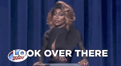 GIF of RuPaul's drag race where a host says "look over there" distracting others
