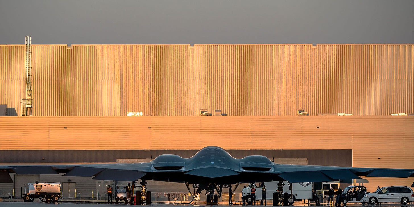 B-2 Spirit Stealth Bomber in front of hanger with full moon in sky