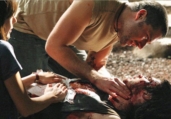 Jack Shephard (Matthew Fox) attends to the badly-mangled form of Boone Carlyle (Ian Somerhalder) while Sun-Hwa Kwon (Yunjin Kim) assists.