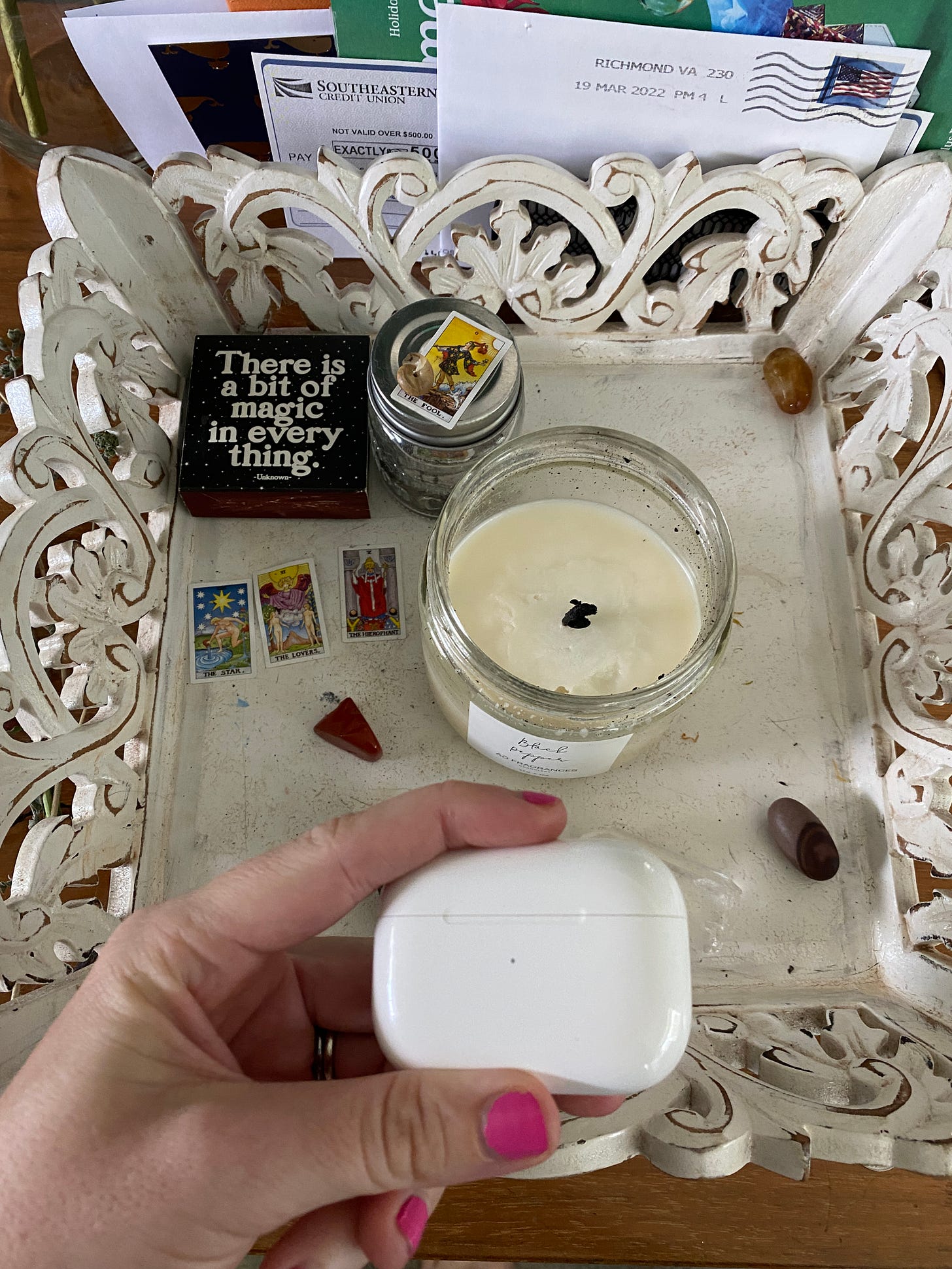 Image of the writer's altar, with a candle and some tarot cards.