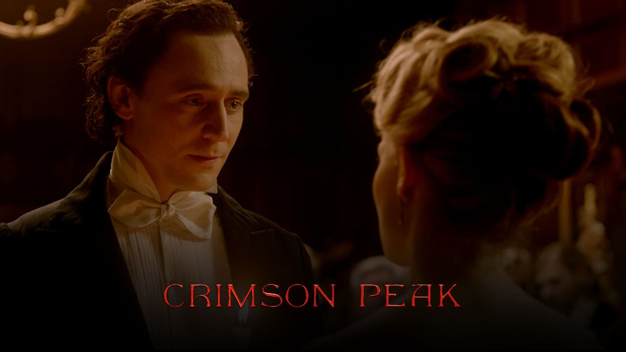 A screencap from the movie "Crimson Peak" with the main romantic couple looking at each other. I'm assuming lovingly.