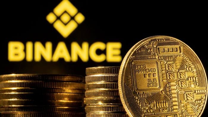 Binance’s logo and a representation of cryptocurrency