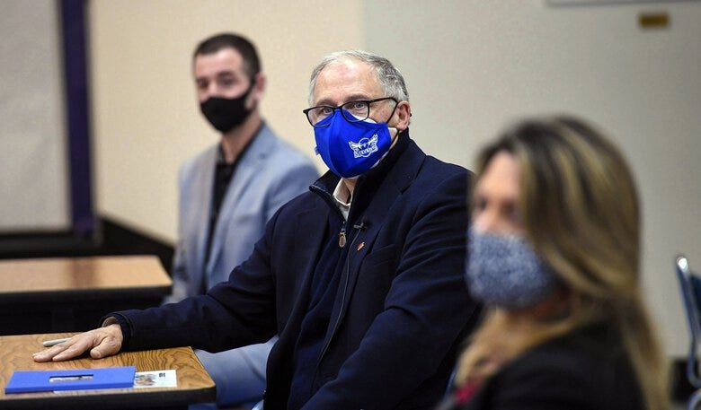 Gov. Jay Inslee signed a bill Tuesday that allows students negatively affected by the pandemic to waive some graduation requirements. Here, he meets with Spokane Public Schools Superintendent Adam Swinyard, left, and Spokane Mayor Nadine Woodward last month. (Dan Pelle / The Associated Press)