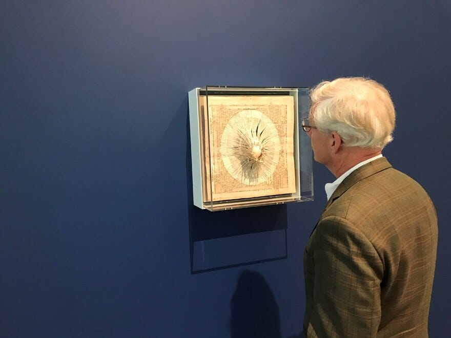 Joe Pierson examines an art piece at the David Rockefeller Creative Arts Center