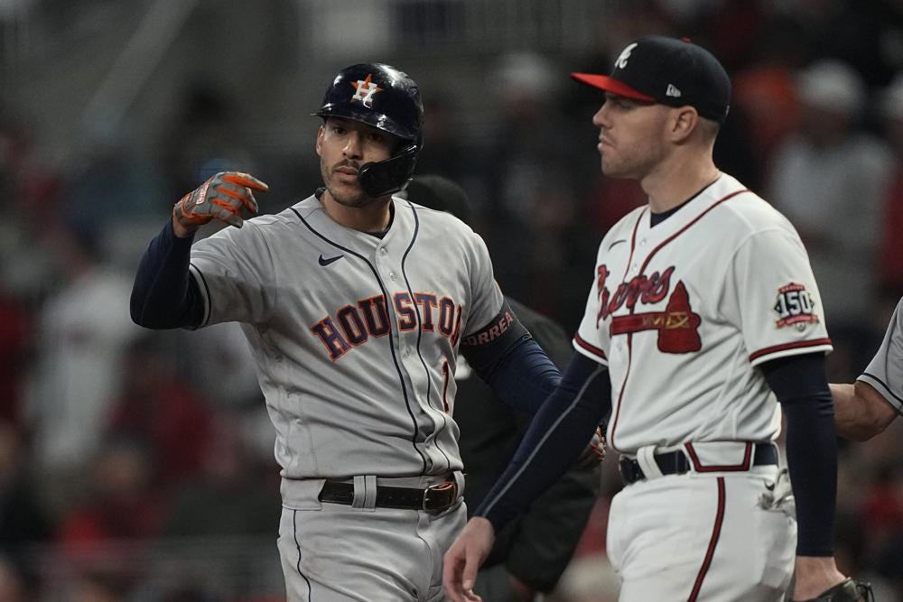 Houston Astros' Carlos Correa celebrates his RBI single during the eighth inning in Game 5 of baseball's World Series between the Houston Astros and the Atlanta Braves Sunday, Oct. 31, 2021, in Atlanta. (AP Photo/David J. Phillip)
