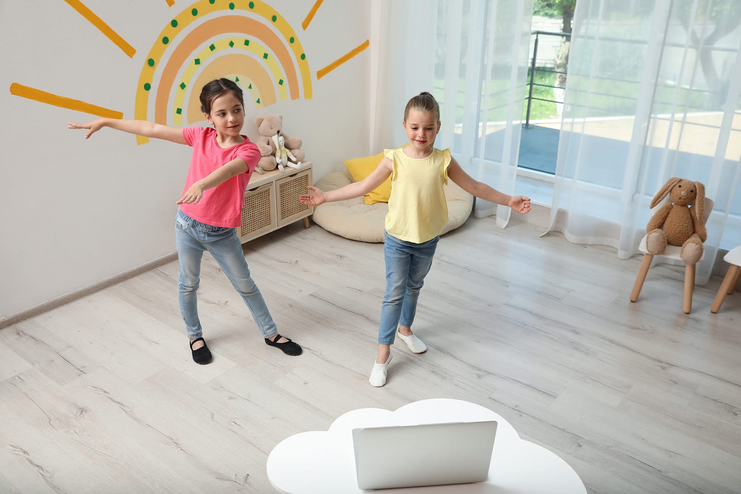 Two children joining a live, online, interactive mindful dance class