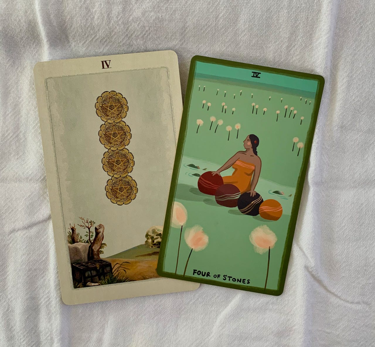 Four of Pentacles from Pagan Otherworlds tarot and Four of Stones from The Gentle Tarot