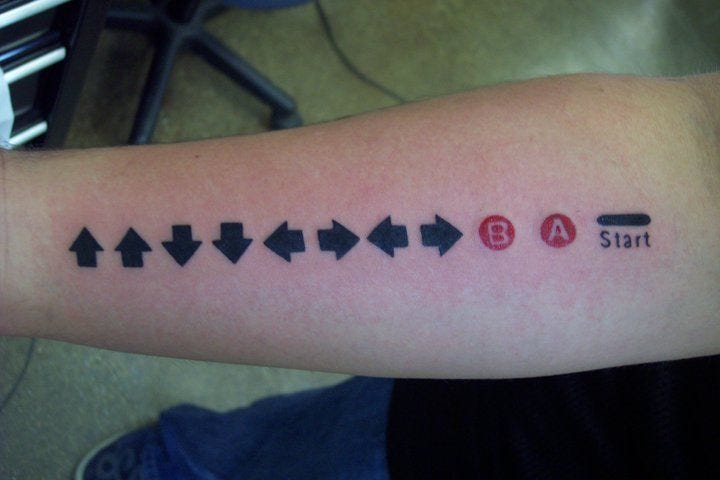Another variation of the Konami code tattoo. Liking the colour buttons! |  Tatuagem
