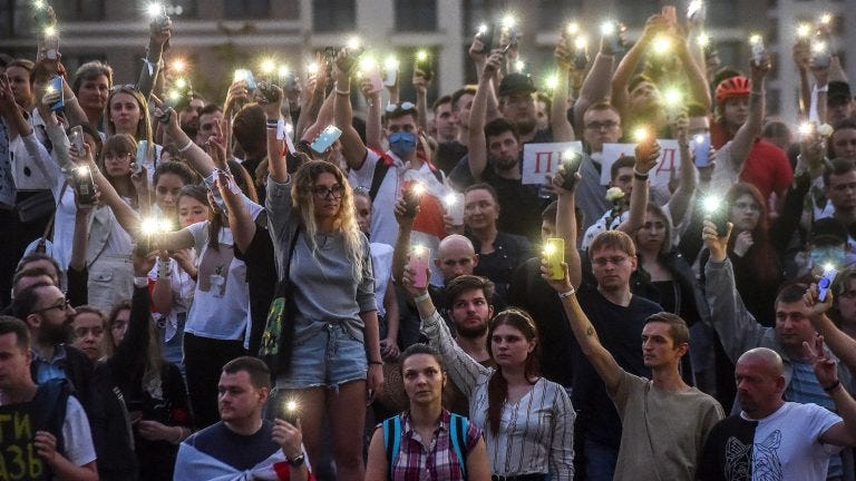 TOPSHOT - Belarus opposition supporters raise their mobile phones with flashlights during a symbolic minute of silence near the State TV and radio company during a protest rally against police violence recent rallies of opposition supporters, who accuse strongman Alexander Lukashenko of falsifying the polls in the presidential election, in central Minsk on August 15, 2020. (Photo by Sergei GAPON / AFP) (Photo by SERGEI GAPON/AFP via Getty Images)