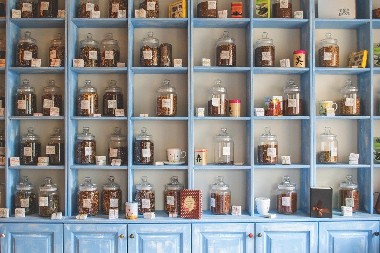 Shelves of glass jars with herbal and Chinese medicine in a store.