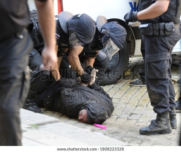 Sofia, Bulgaria - Sep 2 2020: Police officers in helmets bringing a protester to the ground