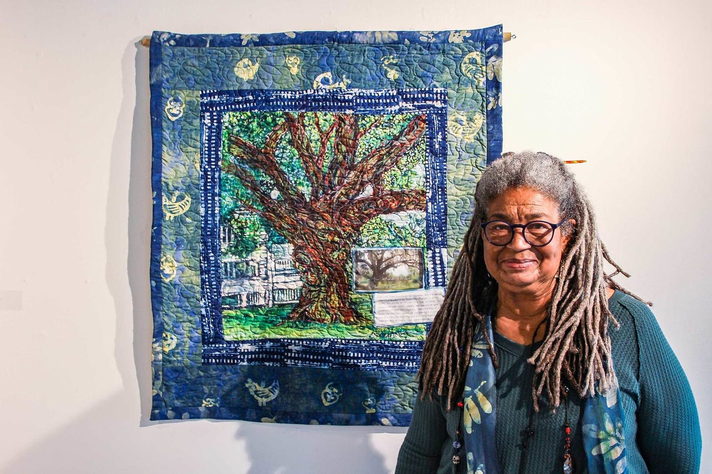 Arianne-King-Comer-poses-with-quilt-art-of-tree-South-Carolina-March-2022-1860x0-c-default.jpg