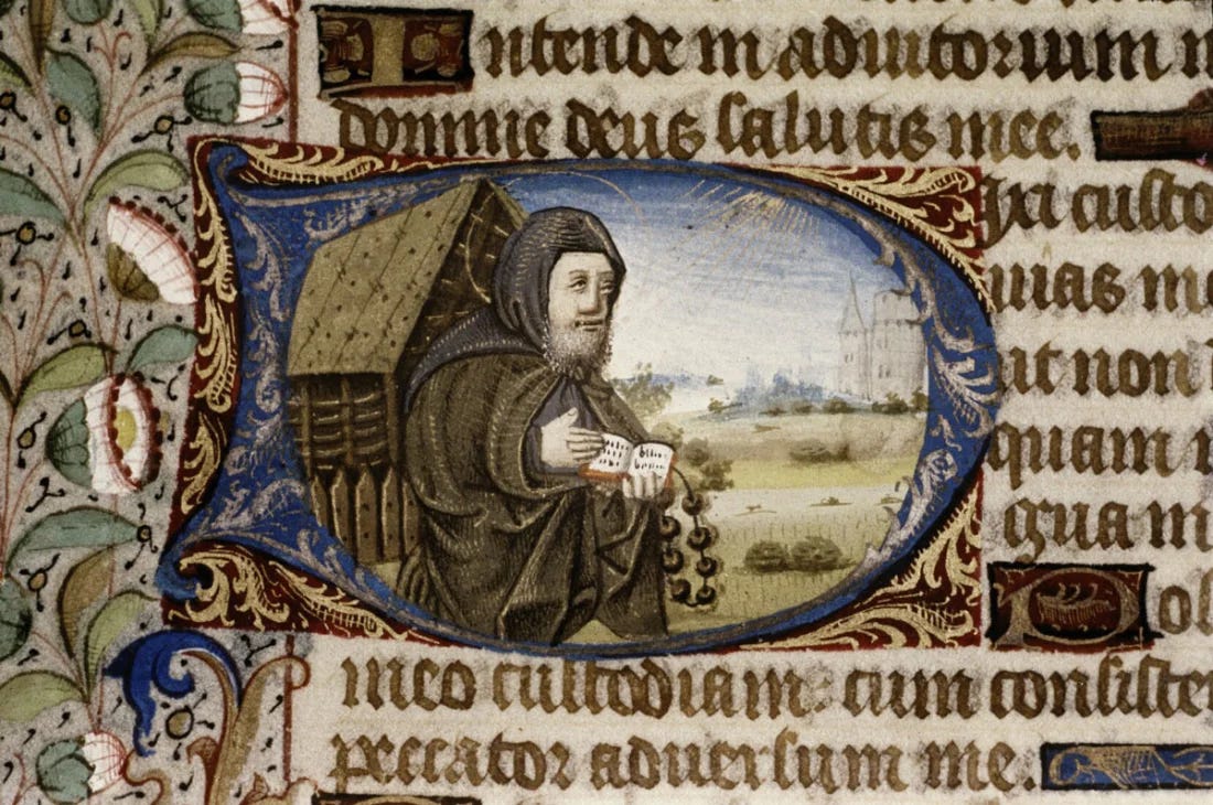 Historiated initial displaying a hermit with rosary and a book.