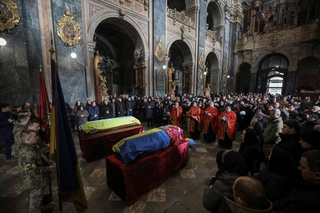 A joint funeral takes place at 'Saint's Peter and Paul Garrison Church', for two soldiers who died in the east of the country during recent fighting.