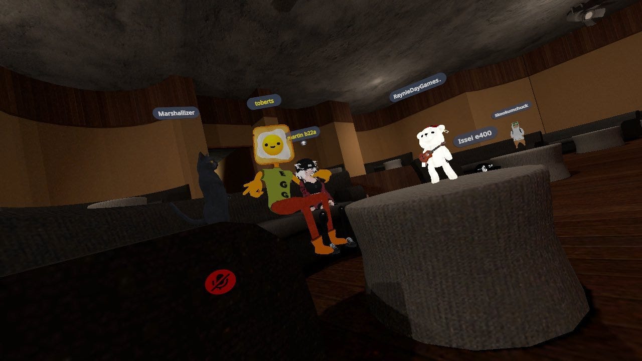 A black cat, a man with egg on toast for a face, a small white bear, and an anime avatar are sitting together in a bland brown room.