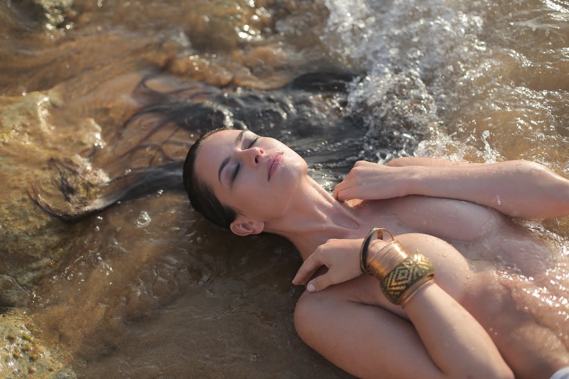 Topless Woman Lying on Water