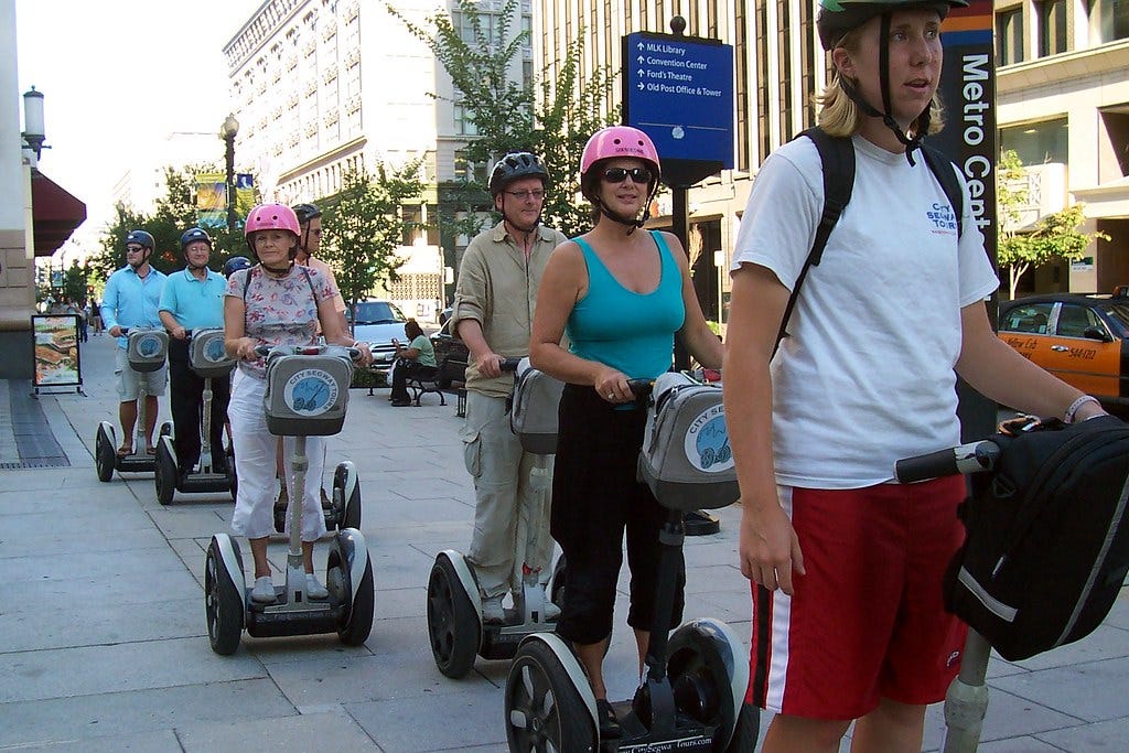 A bunch of tourists on those dumb Segways
