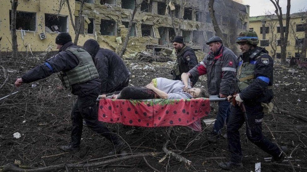 Ukrainian emergency employees and volunteers carry an injured pregnant woman from the damaged by shelling maternity hospital in Mariupol, Ukraine, Wednesday, March 9, 2022 Ukrainian emergency employees and volunteers carry an injured pregnant woman from the damaged by shelling maternity hospital in Mariupol, Ukraine, Wednesday, March 9, 2022