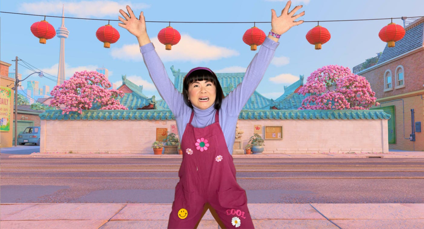 Jenny dressed up as Abby from Turning Red in a purple overalls, lavender turtleneck, purple headband, making an intense screaming face with arms thrown up while standing in front of a cartoon background of the temple from the movie.