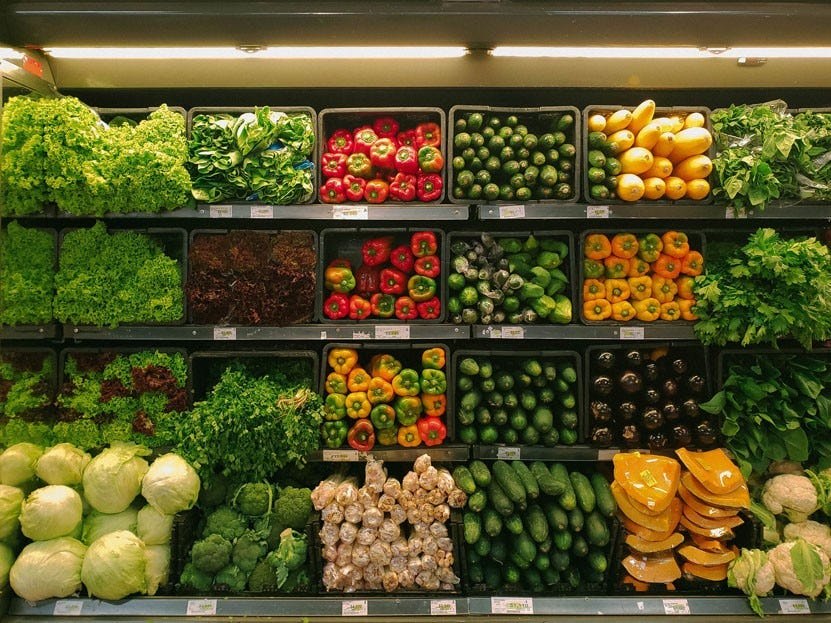 crates of vegetables in a supermarket fridge