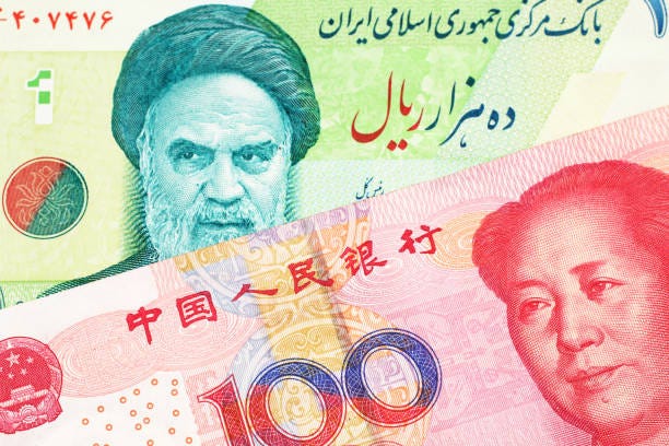 An Iranian rial bill with Chinese money  china iran stock pictures, royalty-free photos & images