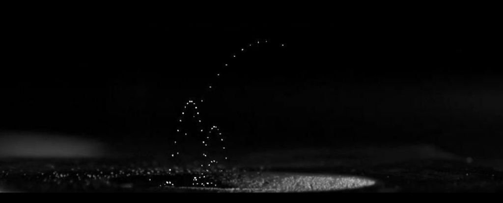 A fountain of lights on a dark lunar dustscape.