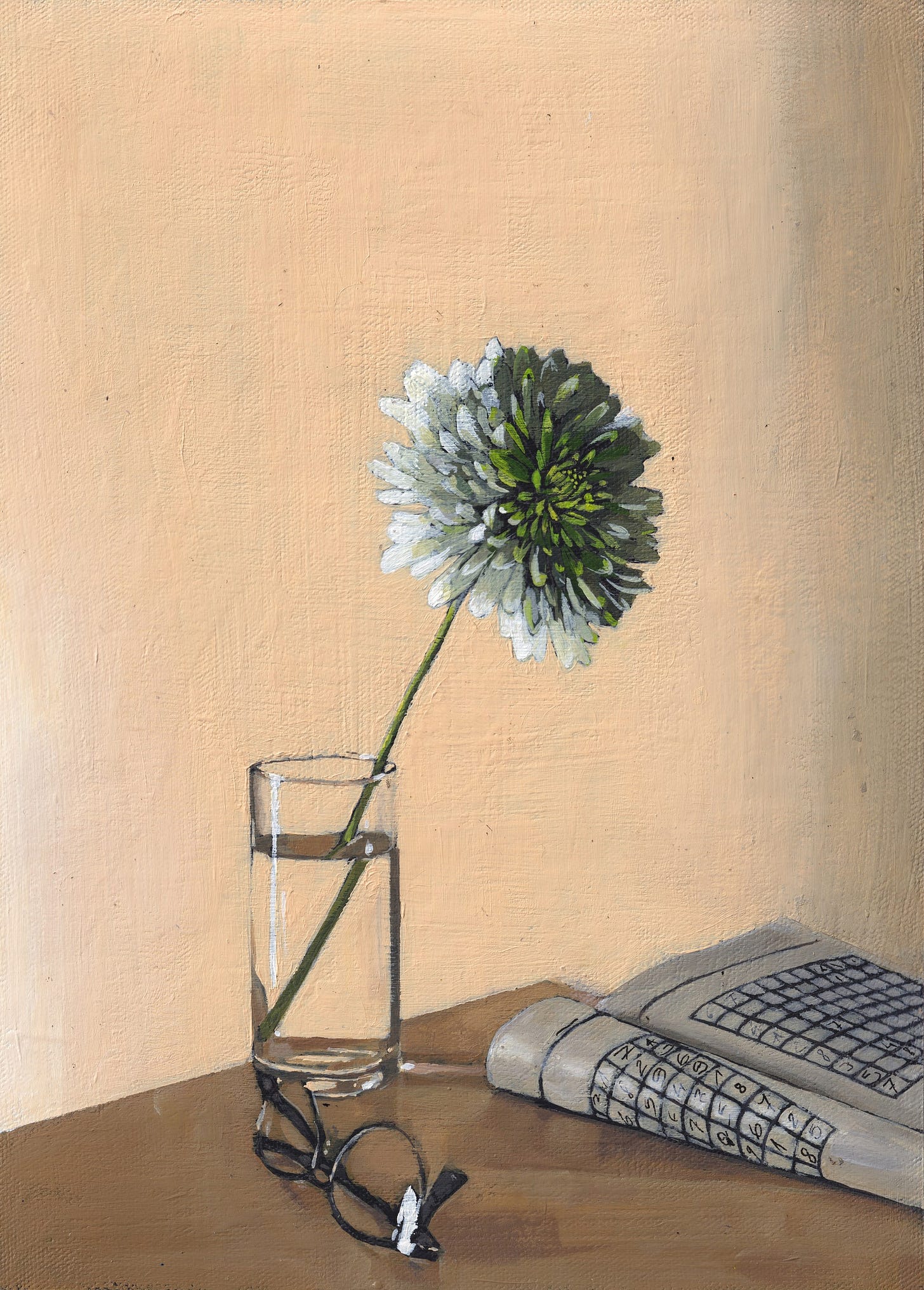 A chrysanthemum flower in a vase next to a sudoku book and glasses.