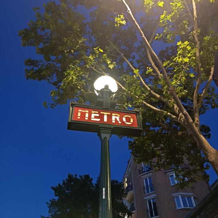Paris Metro sign at night
