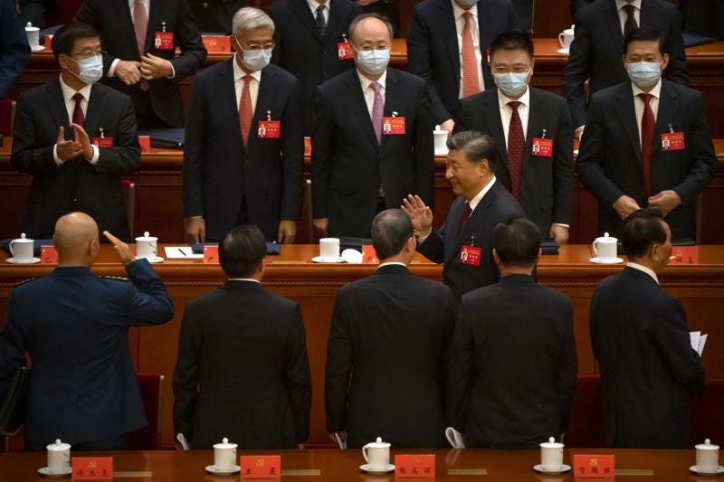 Chinese President Xi Jinping waves as he leaves the opening ceremony of the 20th National Congress of China's ruling Communist Party at the Great Hall of the People in Beijing, Sunday, Oct. 16, 2022.  Xi signaled Sunday that his government would maintain policies that have put it at odds with the U.S. and other nations and deepened Communist Party control of the economy and society. (AP Photo/Mark Schiefelbein)