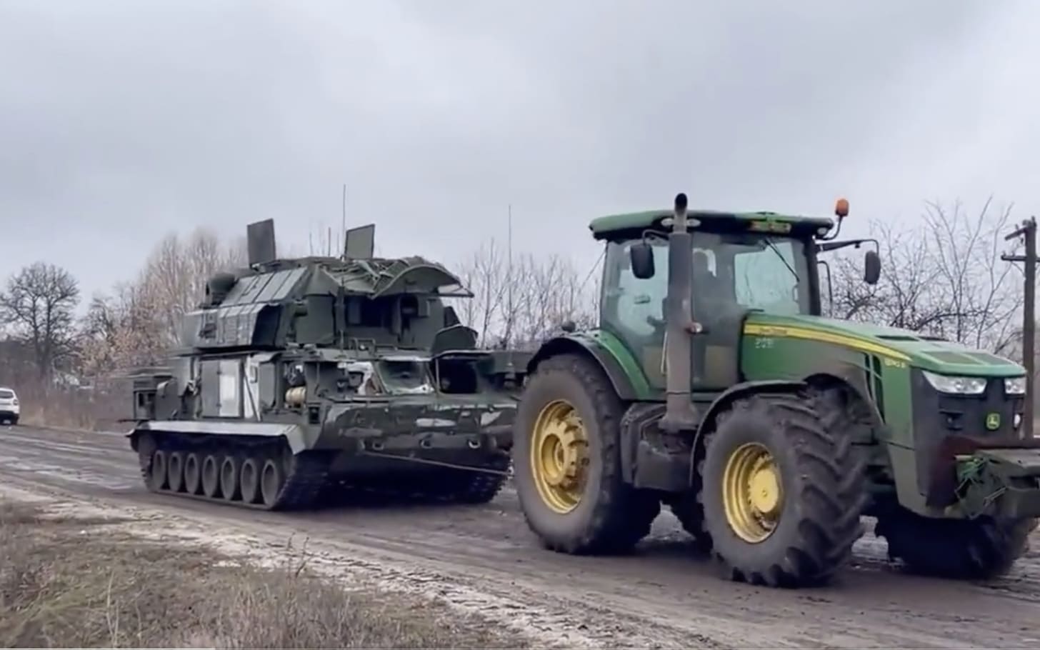 Ukrainian farmers tow away abandoned Russia tanks and missile launchers  worth millions