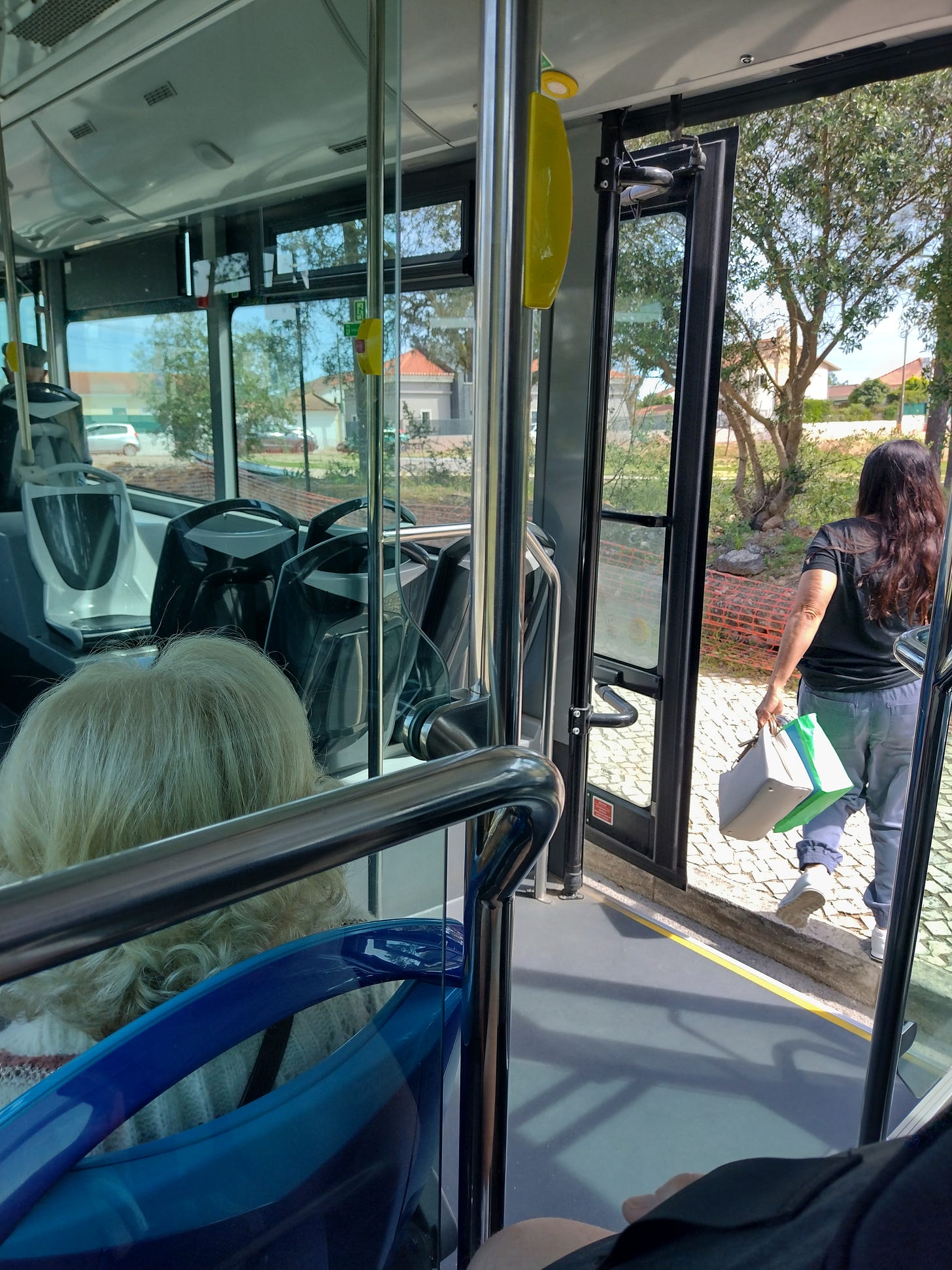 Woman getting out of a bus.