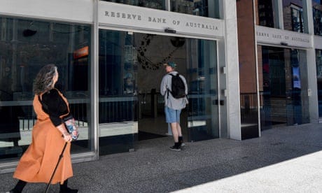 Pedestrians walk past the Reserve Bank of Australia