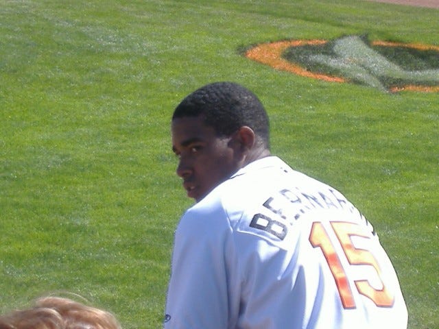 Luis Bernardo looks back toward the dugout before taking his hacks.