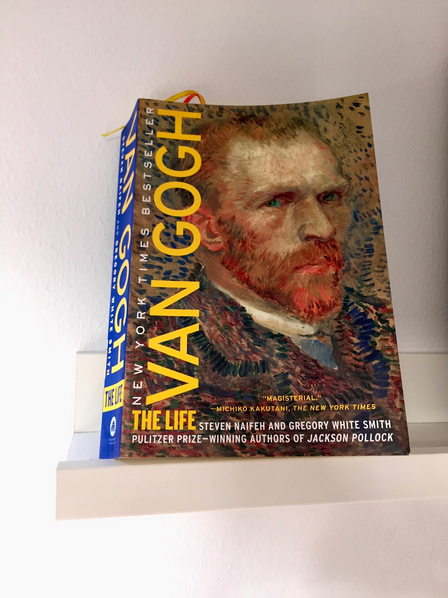 Photo of the book, Van Gogh, The Life by Steven Naifeh and Gregory White Smith. The book cover showed a self-portrait of Vincent van Gogh, his piercing blue eyes seems to be looking intensely at the viewer. He has ginger reddish coloured beard, and his hairline has started to recede. He appeared to be wearing a jacket.