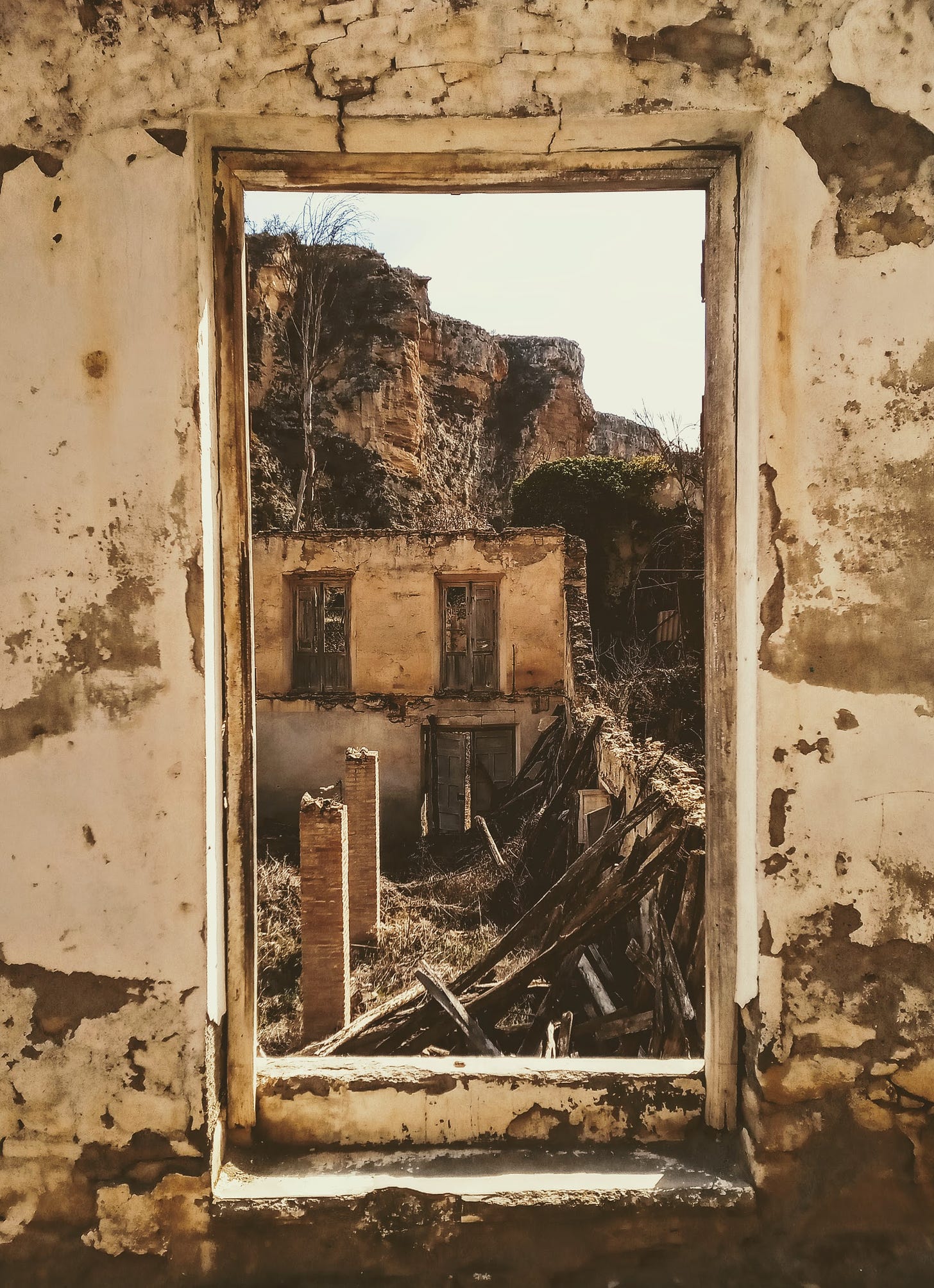 Ruins of old mill house at Alhama de Granada, steep cliffs of river gorge in background, viewed through the door of the mill house ruins. 