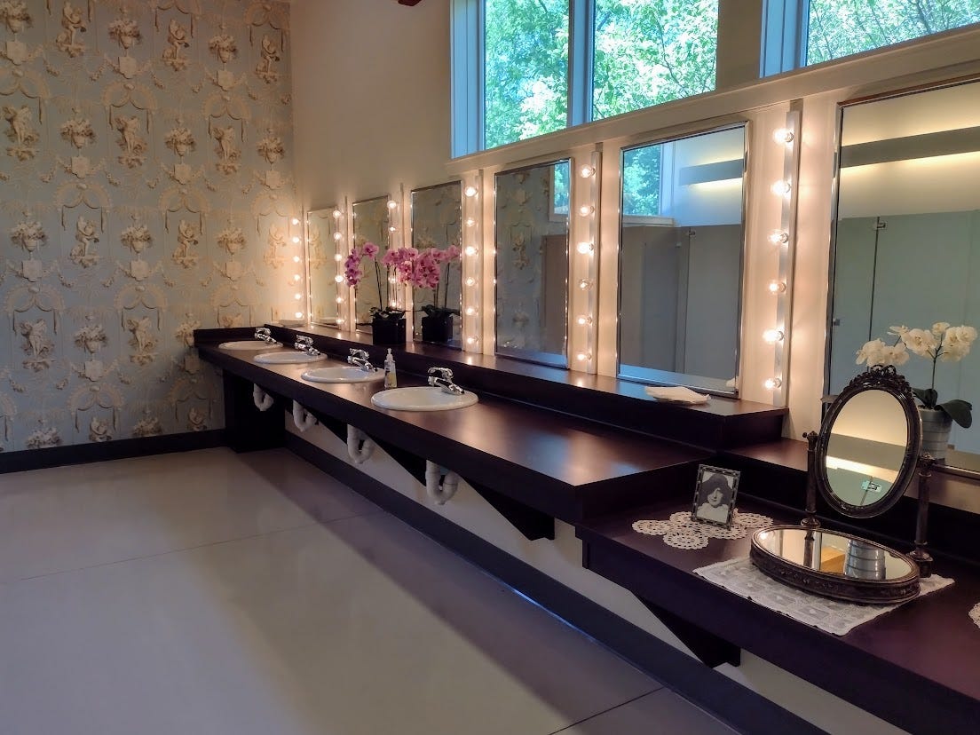 Restroom with flowers and stage lights