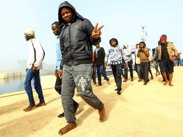An African migrant flashes the victory gesture after disembarking following his rescue from off the coast of Zawiyah, about 45 kilometres west of the Libyan capital Tripoli, at the dock at the capital's naval base on March 10, 2018. / AFP PHOTO / MAHMUD TURKIA (Photo credit should read MAHMUD TURKIA/AFP/Getty Images)