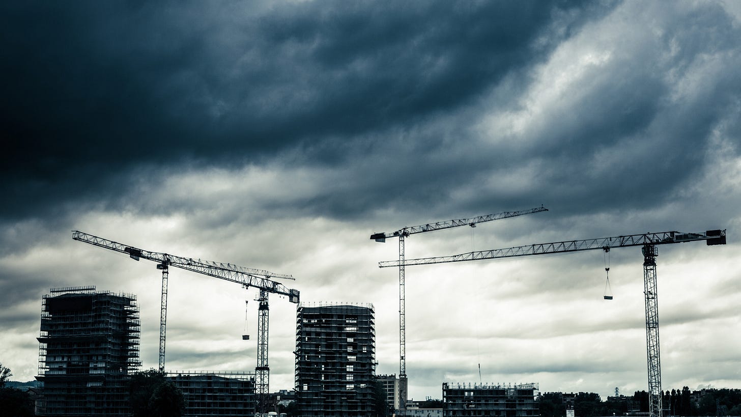 An industrial construction site with a cloudy sky